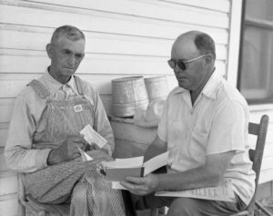 W.A. Cassell of Elmore City (left) signs up for his Garvin County Farm Bureau membership with A.J. Chapman, Membership Committee Co-chairman. Cassell was the first new member to be added in the county during in the organization’s 1953 campaign.