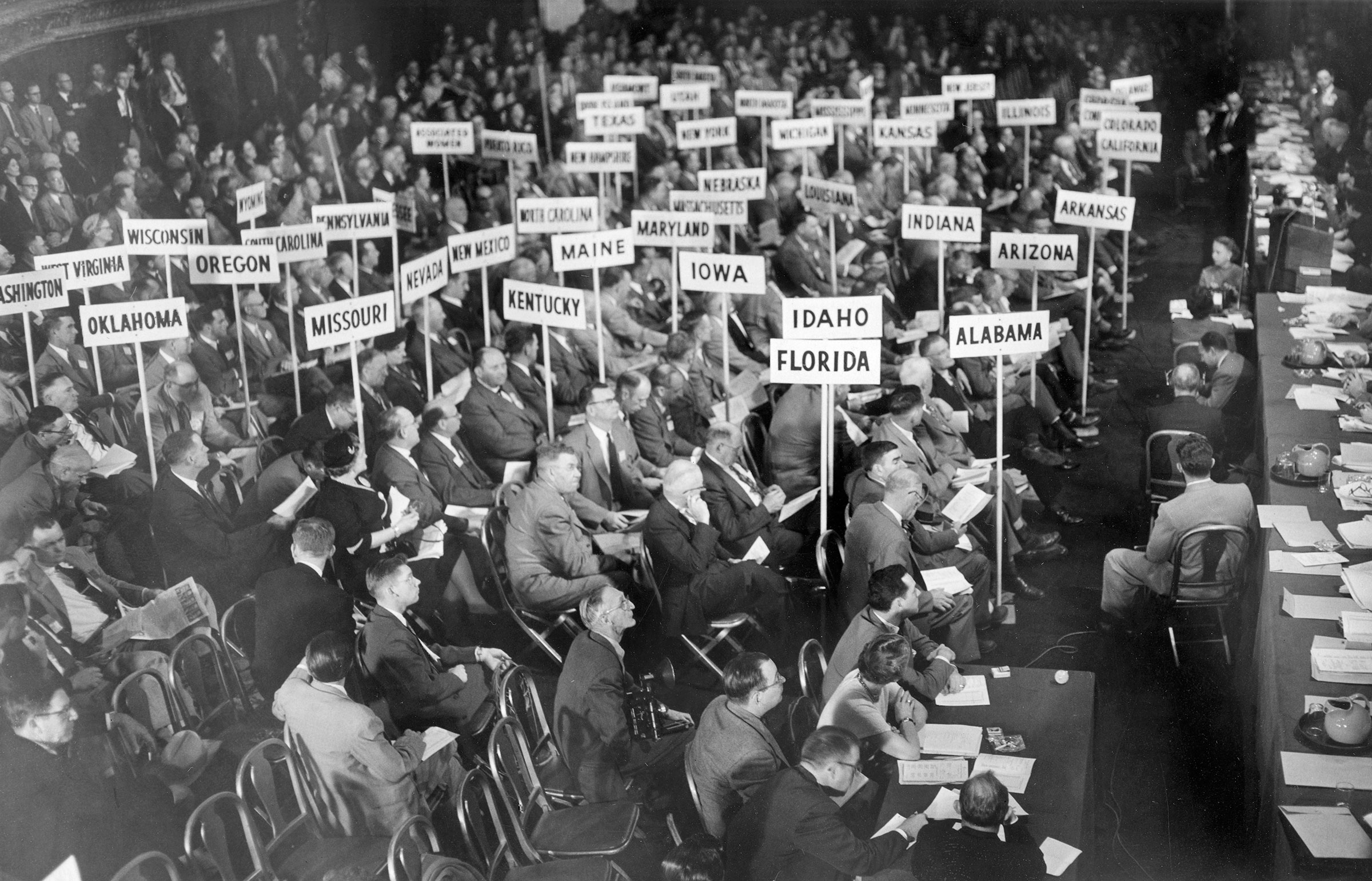 Voting delegates from 48 states and Puerto Rico consider the resolutions that determine the policies of the American Farm Bureau Federation for 1954 during the AFBF annual meeting held in New York City. Oklahoma’s delegation is seated in the left foreground.