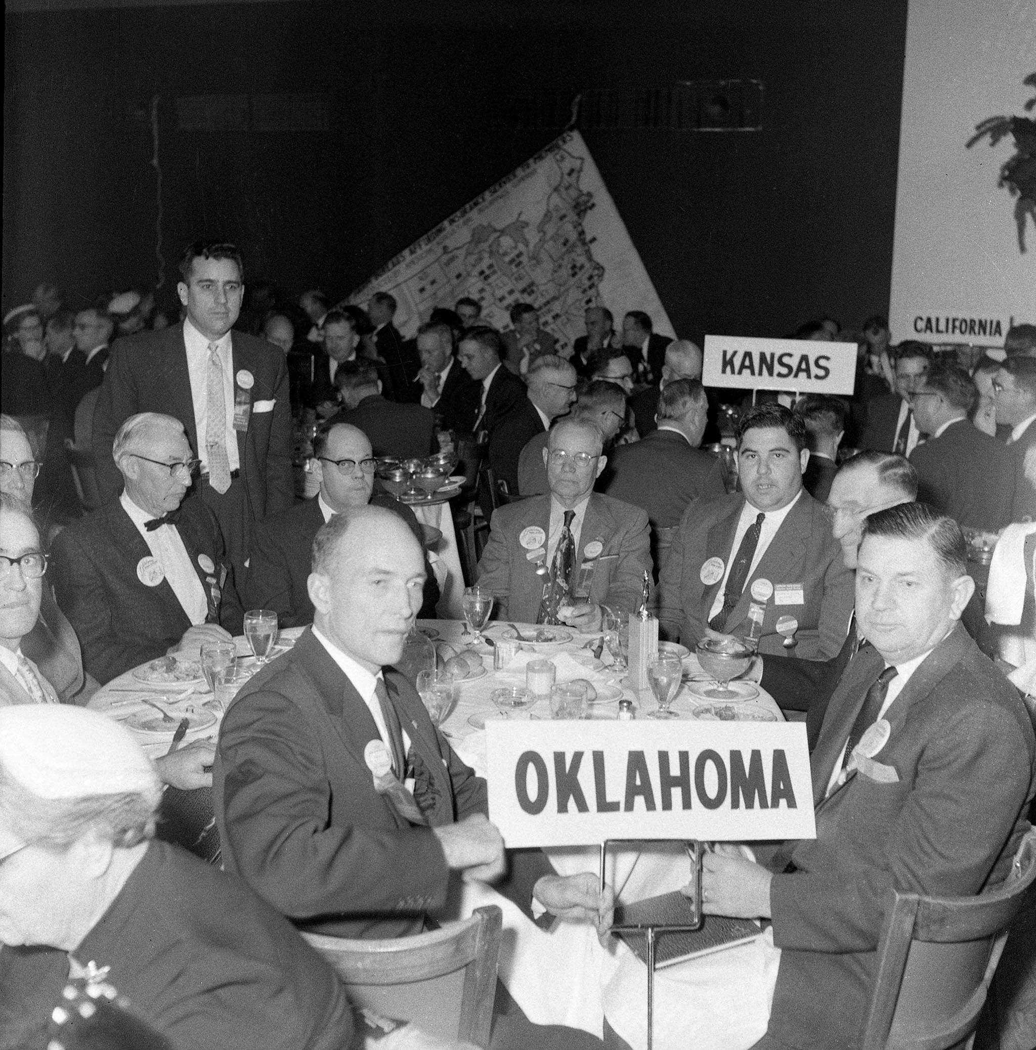 Forty-six Oklahomans attended the 37th annual meeting of the American Farm Bureau Federation in December 1955, including Oklahoma Farm Bureau’s four voting delegates: President Lewis H. Munn; Harold Davis, Roff; Mart Fowler, Stigler; and W.M. Deck, Balko. During the business session, delegates considered several resolutions concerning a variety of issues, including the Agricultural Act of 1954, the adoption of a “soil bank” policy to stockpile fertility in the soil for use in emergencies, states’ rights and more.