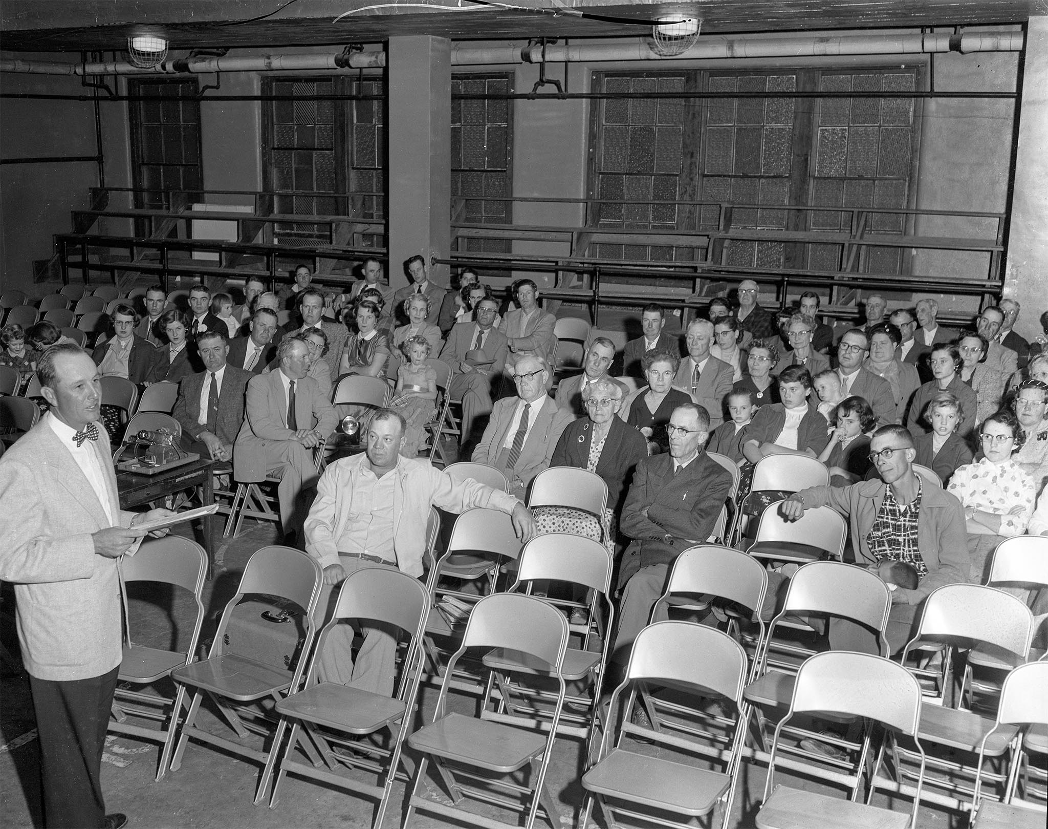Doyle Johnson, chairman of the Alfalfa County Farm Bureau resolutions committee, presents proposed resolutions to his fellow county members at their annual meeting in October 1955.