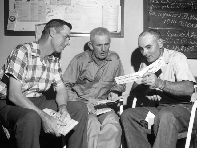This photo was taken at a Custer County Farm Bureau membership kickoff held at the county office on October 7, 1958. Pictured are (left to right) Roy Driscoll, Custer County Farm Bureau Board member from Clinton; Wayne Foster, county board member from Weatherford; and Con Burgtorf, Membership Chairman from Custer City.
