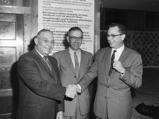 American Farm Bureau Federation staff member Warren Newberry, who also served as the first president of the Oklahoma Junior Farm Bureau, was a guest speaker at the Town and Country Banquet for Garvin County Farm Bureau held in Pauls Valley on January 25, 1960. Here (left to right) Pierre Grimmett, President of Pauls Valley National Bank; Alvin Powell, county Farm Bureau President; and Newberry visit after the meeting had ended. Almost 500 Farm Bureau members and guests were present for the meeting.