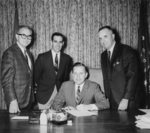 In 1968, Oklahoma Farm Bureau drafted a bill referred to as the Right-to-Market bill, which increased penalties and specifically prohibited interference by force, coercion or intimidation of persons seeking to market farm products. The bill was aimed at giving additional protection against violence, such as that which occurred in the Midwest in prior years during withholding actions of the National Farmers Organization. This photo was taken as Gov. Dewey Bartlett signed the Farm-Bureau-sponsored bill into law as OKFB Executive Secretary Kenneth McFall, Sen. Anthony Massad of Frederick and Rep. Harold Hunter of Waukomis looked on. Massad was the Senate author for the bill, and Hunter was one of the chief supporters of the bill in the House.