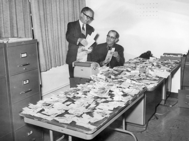 Keeping up with the latest legislative and county news is an important part of Oklahoma Farm Bureau. This 1970 photo features Lewis H. Munn, OKFB President (right), reviewing newspaper clippings about the organization’s activities with Kenneth McFall, Executive Secretary. The stories, gathered by a press clipping service, represent news coverage from nearly every newspaper in Oklahoma on topics ranging from county board meetings to farm news on the state level. Clippings were grouped and returned to appropriate county Farm Bureaus featured in the stories.