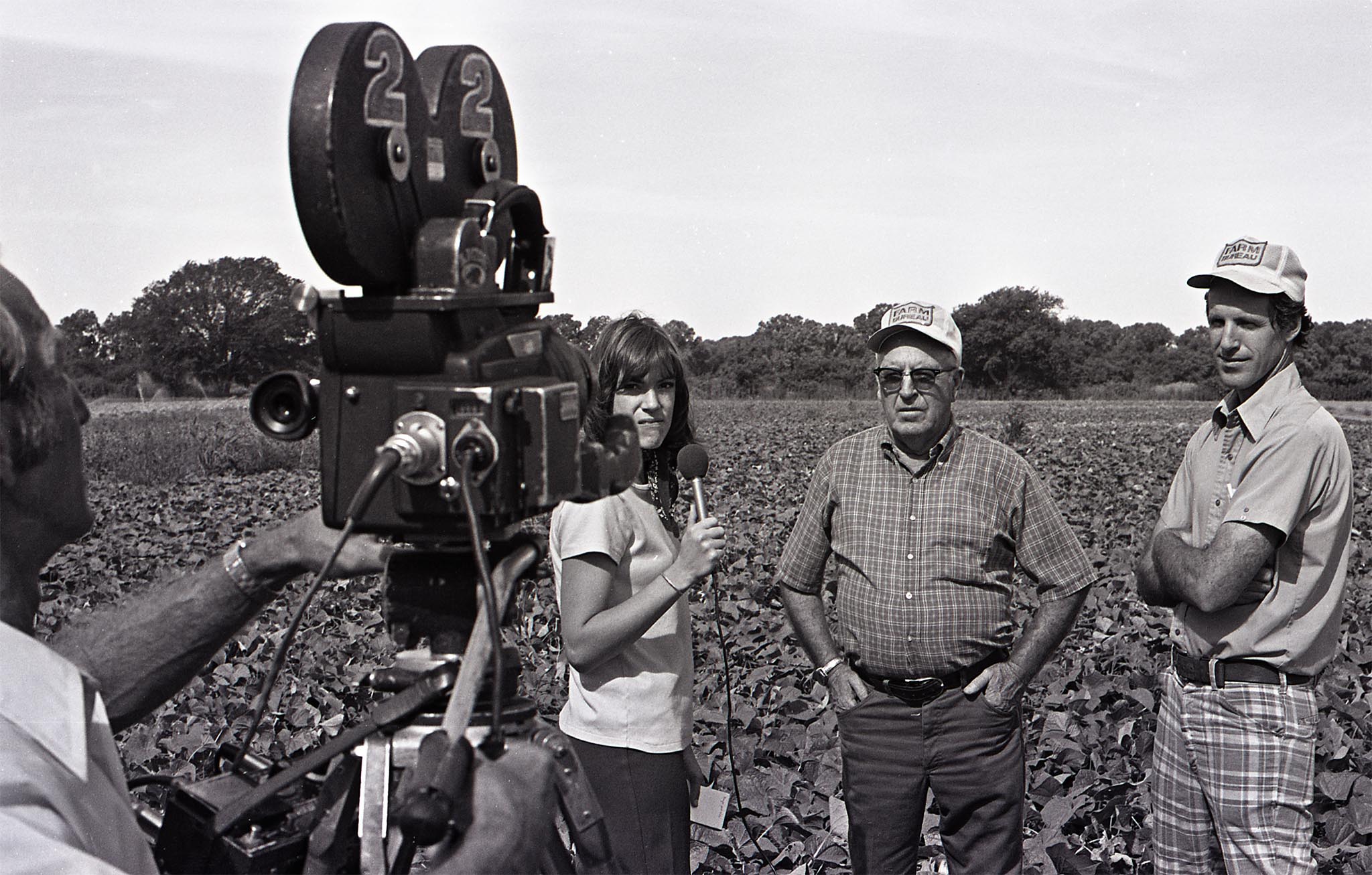 In this photo from 1975, OKFB member Eugene Conrad and his father, Chester, both of Bixby, spoke to a reporter from Tulsa’s KTEW-TV about the advantageous uses of agriculture pesticides and herbicides in food production.