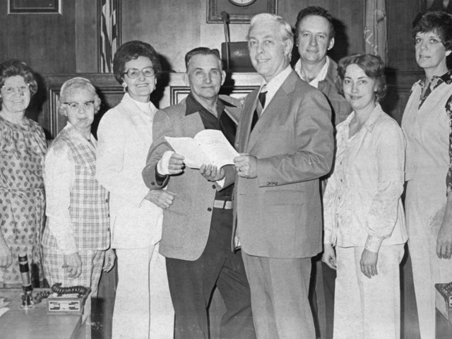 Here, representatives of the Muskogee County Farm Bureau met with State Sen. John Luton, Senate Majority Leader Whip, to discuss agricultural matters in 1979. With Sen. Luton are (left to right) Mrs. Bob Murr of Oktah, Mrs. Dick Helmer of Route Three, Mr. and Mrs. Jim Leeds of Fort Gibson, Sen. Luton, Mr. and Mrs. Robert Plunkett of Route Two and Mrs. Arlie Perry of Fort Gibson.