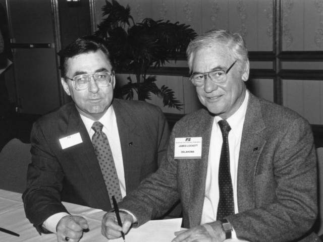 In this 1990 photo, James Lockett, OKFB President (right), pictured with American Farm Bureau Federation President Dean Kleckner, signs a Farm Bureau petition favoring reduction of the capital gains tax.