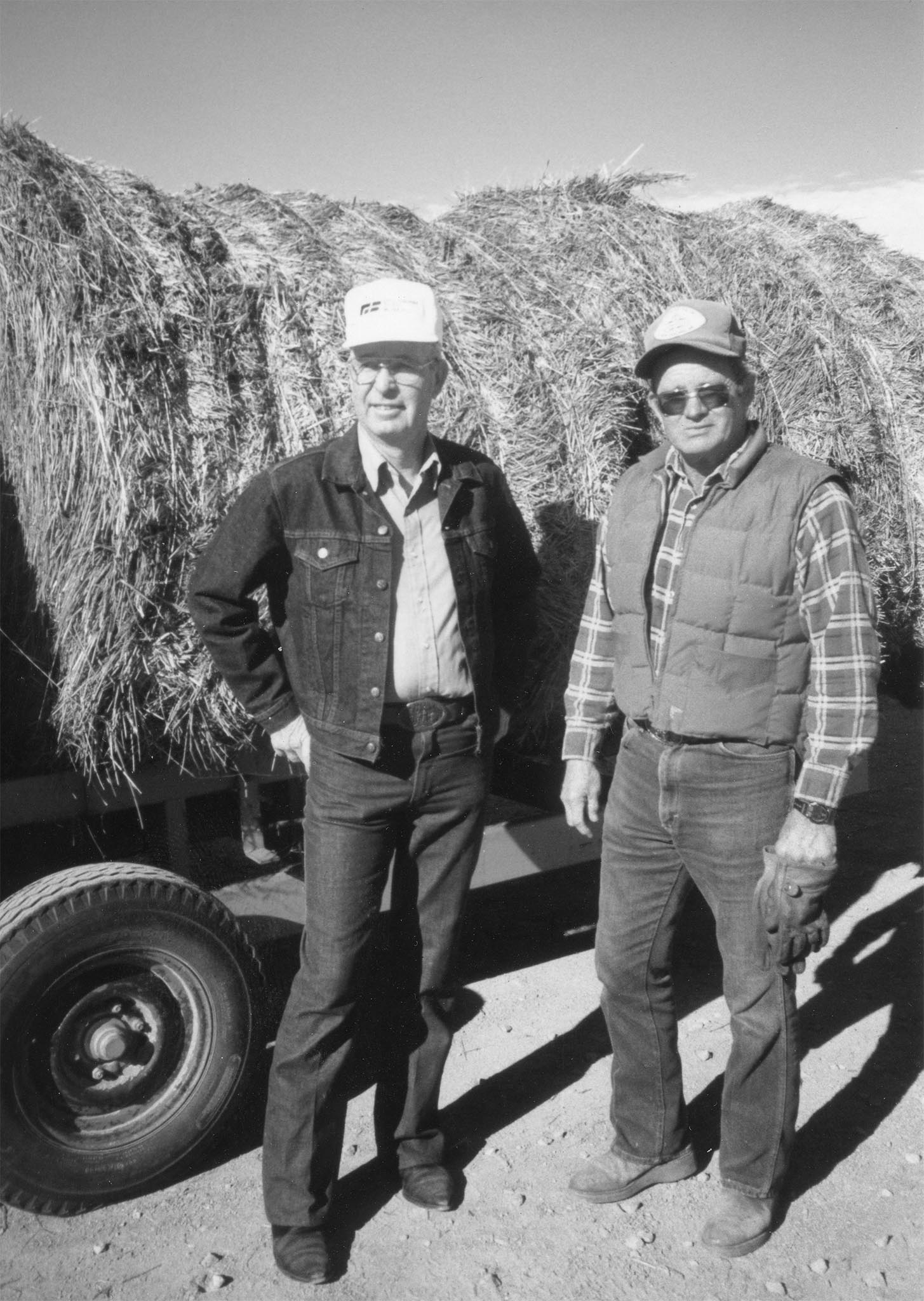 In 1990, about 100 Oklahoma farmers and ranchers donated more than 300 tons of hay to drought-stricken parts of south Texas. The donations came as a result of the “South Texas Haylift,” a cooperative effort among Farm Bureau members that grew to encompass even non-members. Shown here, Logan County Farm Bureau President Bill Kinney (left) and Vice President Oliver Rudd watch donated hay being loaded onto railcars as they stand in front of a trailer waiting to be unloaded. The hay was loaded on the railcars at the Marshall Co-op and the Guthrie Santa Fe depot and routed to Texas cattlemen in Bexar, Atascoas and Victoria counties, where accumulated rainfall was less than 12 inches in the previous two years.