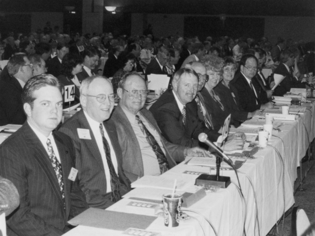 During the 1995 American Farm Bureau Federation annual meeting in St. Louis, Missouri, policy work in preparation for the upcoming farm bill took center stage. Delegates advocated for a more flexible approach to farm programs, as the delegate body passed a resolution opposing all tax increases and calling for a freeze in federal spending. Members of the 1995 Oklahoma delegation included (left to right) Oklahoma Farm Bureau Young Farmers & Ranchers Chairman Ryan Pjesky, OKFB President Eldon Merklin, Cotton County’s Clarence Vache, OKFB Vice President Steve Kouplen, OKFB Board Member Billy Gibson, Farm Bureau Women’s Committee Members Beverly Delmedico and Juanita Bolay, and OKFB Board Member Ron Henson.
