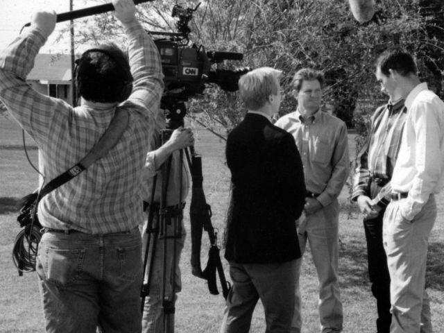 In this photo, CNN Newsman David Steck interviews OKFB Young Farmers & Ranchers members Tom Null, Keeff Felty and Matt Muller about weather forecasting’s impact on farming. The CNN crew was in Oklahoma on April 21, 1998, to videotape a story on severe weather awareness, and quizzed the YF&R members about any folklore-type indicators farmers recognized as precursors of storms.