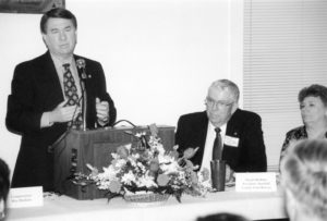 Almost 80 Farm Bureau members from five counties in southeastern Oklahoma assembled in Madill on April 6, 1998, to host U.S. Rep. Wes Watkins. It was the first time for Marshall County Farm Bureau to host a special legislative meeting featuring the third-district U.S. congressman. Marshall County Farm Bureau President Dwain Rushing listened as Rep. Watkins briefed leaders on some of the upcoming issues that would face Congress.