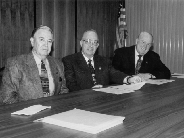 In 1998, presidents of the Oklahoma Farmers Union, Oklahoma Farm Bureau and the Oklahoma Cattlemen’s Association joined leaders of other state organizations to create the Oklahoma Agriculture Roundtable. The group united forces on several agriculture industry issues on the table for the 1998 legislative session, such as the wheat checkoff, estate taxes, livestock liability and more. This photo was taken as OKFB President Jack M. Givens (left), OCA President Stanley Barby (center), and OFU President Phil Klutts prepared to open the Oklahoma Agriculture Roundtable.