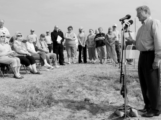 U.S. Sen. Jim Inhofe, standing in an old buffalo wallow, speaks against government overreach in proposed changes to the Clean Water Act during a 2012 press conference hosted by Oklahoma Farm Bureau. The press event was held on land owned by Garfield County Farm Bureau member Gary Johnson.q