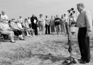 U.S. Sen. Jim Inhofe, standing in an old buffalo wallow, speaks against government overreach in proposed changes to the Clean Water Act during a 2012 press conference hosted by Oklahoma Farm Bureau. The press event was held on land owned by Garfield County Farm Bureau member Gary Johnson.q