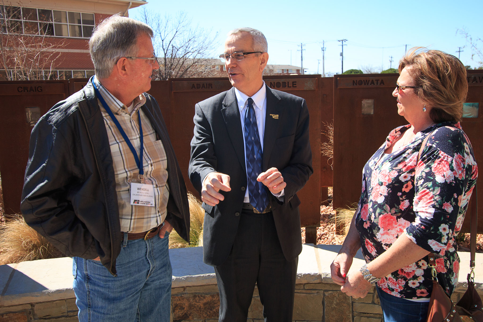 Oklahoma Secretary of Agriculture Jim Reese (center) visits with Farm Bureau members during the commemorative courtyard dedication on March 7, 2017.