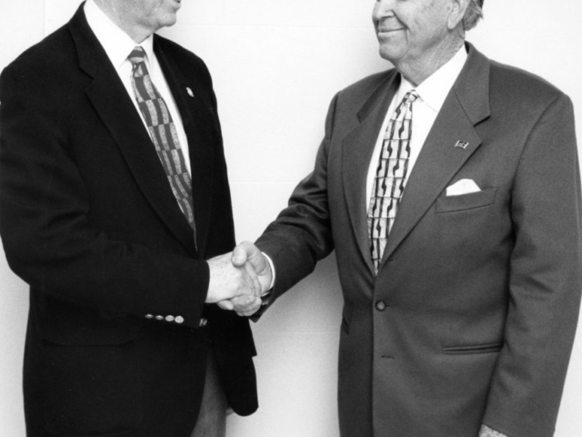 Oklahoma Farm Bureau Vice President Jack Givens, right, offers congratulations to Sen. Gilmer Capps upon the Snyder legislator being named winner of the Oklahoma Association of Conservation Districts’ Hall of Fame Award in 1997.