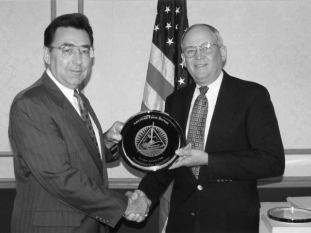 OKFB President Eldon Merklin (right) receives Leader Award in 1996.